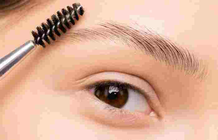 applying castor oil on eyebrows